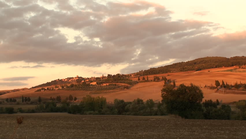 The road to the little town of Monticchiello as the sun sets over the Val d'Orcia in Tuscany, Italy