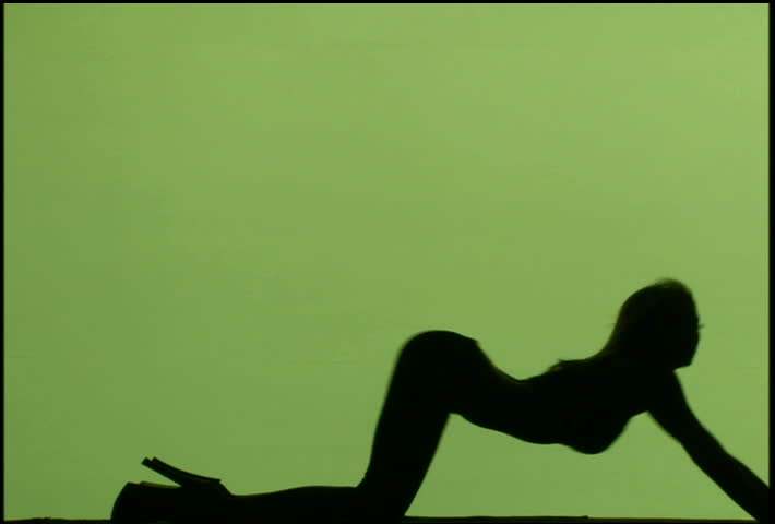A silhouetted woman dancing against green background