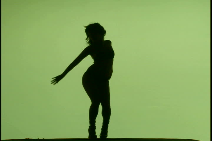A woman's silhouette dancing against green background