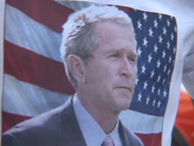 BAGHDAD - CIRCA 2003: An Iraqi man in Baghdad proudly gives the peace sign while wearing a President Bush tee shirt circa 2003 in Baghdad.