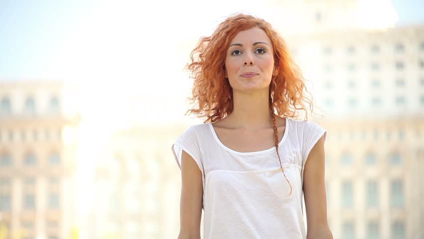 Excited adult pretty young woman makes air quotes and smiles. 