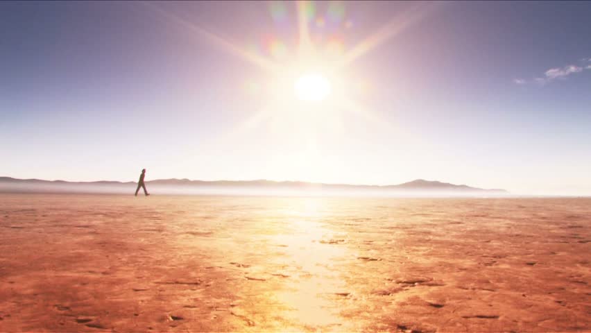 Man walking across horizon (desert)