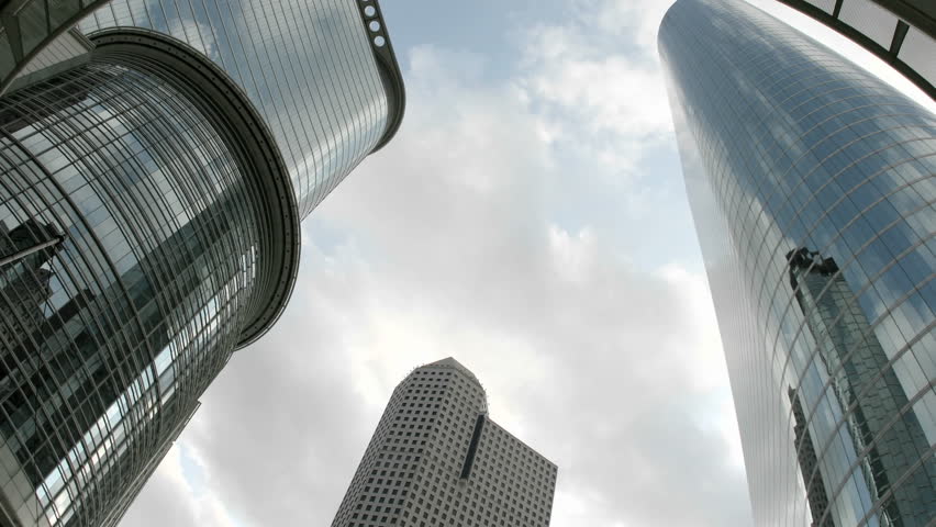 Slow upward pan of the Houston Oil Company Buildings seen from beneath an arch.