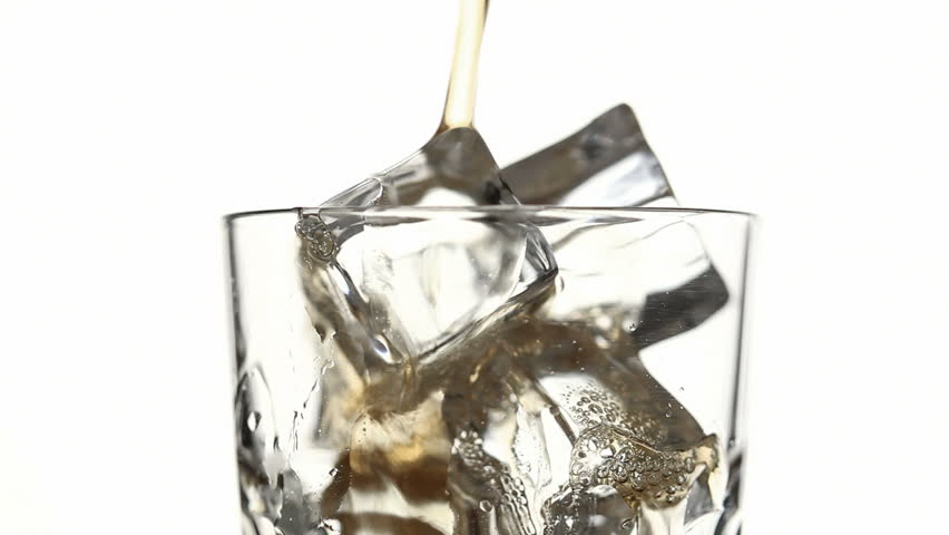 close up of glass pouring cola