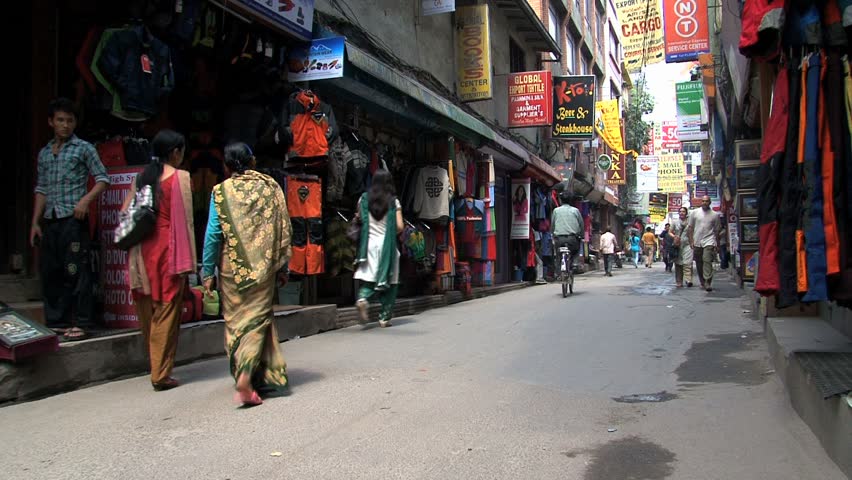 KATHMANDU - CIRCA 2010: People, cars and bikes circulate through the city circa 2010 in Kathmandu.