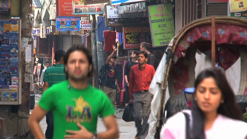 KATHMANDU - CIRCA 2010: People, cars and bikes circulate through the city circa 2010 in Kathmandu.