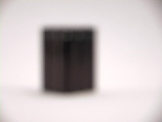 Rack focus to reveal six portable electronic device batteries.
