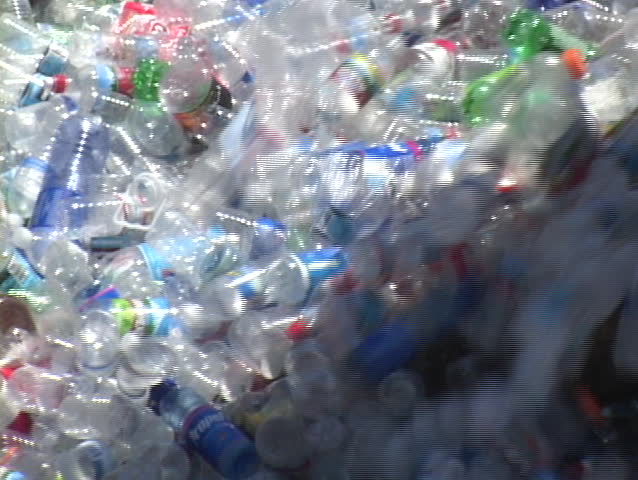 VENTURA, CALIFORNIA - CIRCA 2009: Thousands of plastic bottles pour out of a container in a recycling center.
