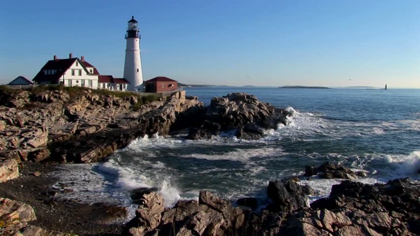 The Portland Head Lighthouse oversees the ocean from rocks in Maine, New England. 