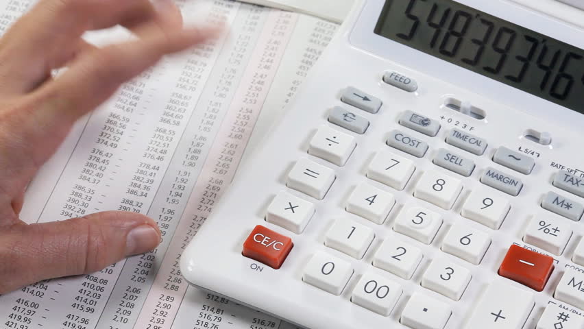 Accounting. Business woman working with a calculator and documents.  