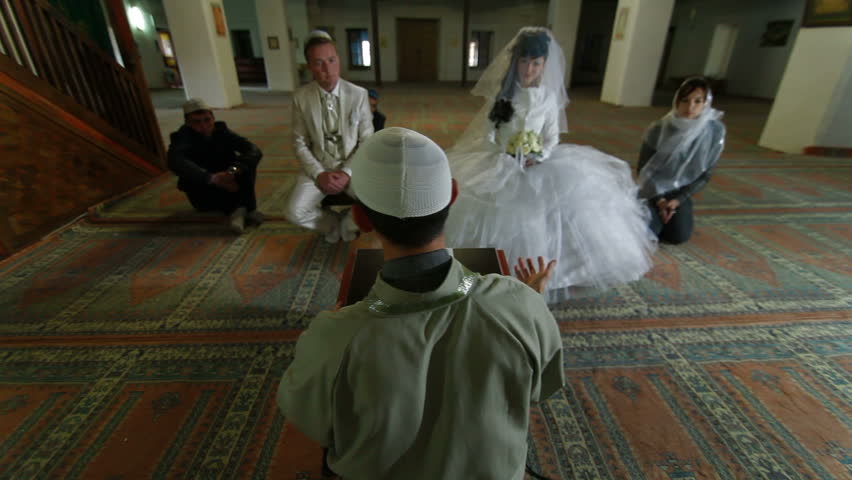 Imam (islamic priest) preaching at the Wedding Ceremony Nikah of Crimean Tatars in Mosque. Bakhchisaray Palace (Hansaray, Khan's Palace) Bakhchisaray, Crimea, Ukraine. lockdown, Wide Shot