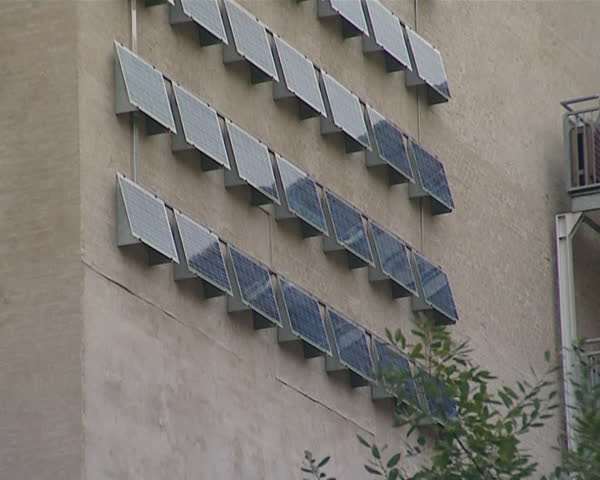 Building wall fragment with lot of solar collectors. Renewable ecological solar energy. 
