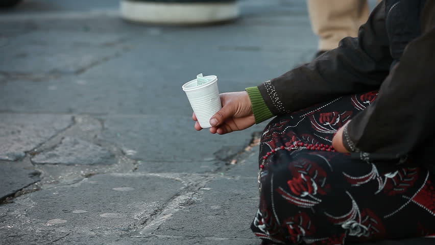 Woman homeless in city begging