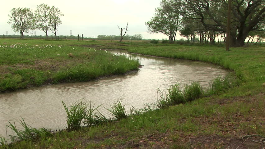 stream winding through farm property