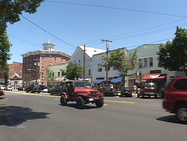 LONG ISLAND, NY - CIRCA 2005: People stroll down the sidewalk in a quaint town circa 2005 in Long Island.