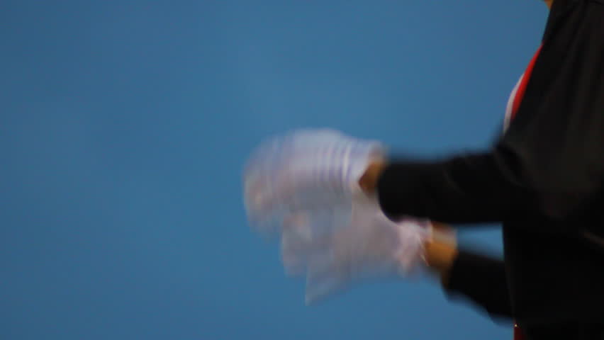 Close up of a marching band conductors hands.