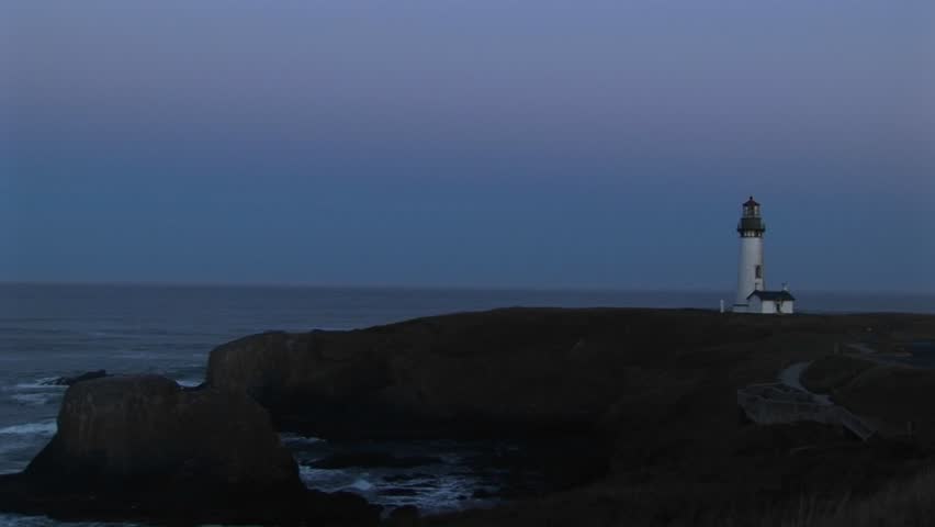 Wide shot of lighthouse with beacon flashing