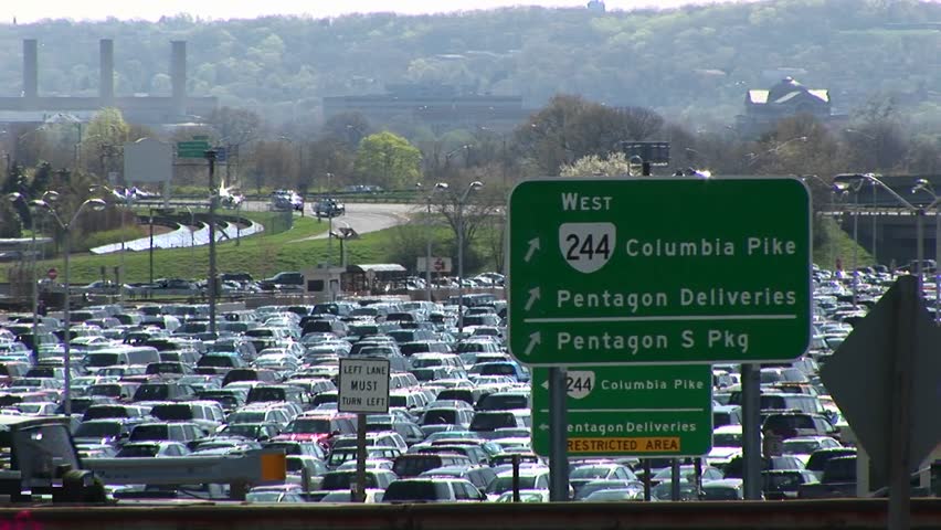A green road sign gives directions for travel in Washington, DC