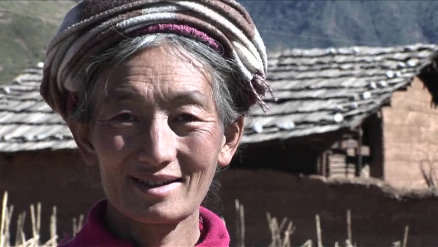 CHINA - CIRCA 2009: A tribal woman smiles at the camera, circa 2009 in China.