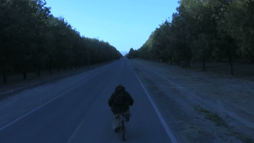 Biking down a road in a cold day