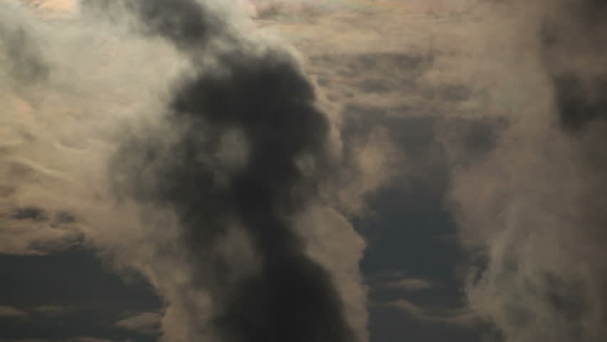 Heavy pollution, environment issues.. Smoke stakes against cloudy sky. 