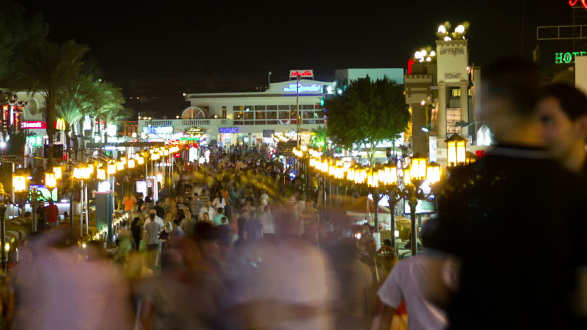 SHARM-EL-SHEIK, EGYPT - OCTOBER 2011: (Timelapse View) Crowds of people walk on a busy shopping street at night circa October 2011 in Sharm-el-Sheik, Egypt. 