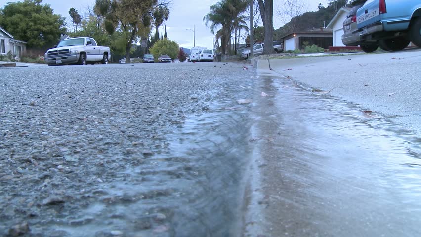 OAK VIEW, CA - CIRCA 2009: Water running off the sidewalk after a rain circa 2009 in Oak View, CA.