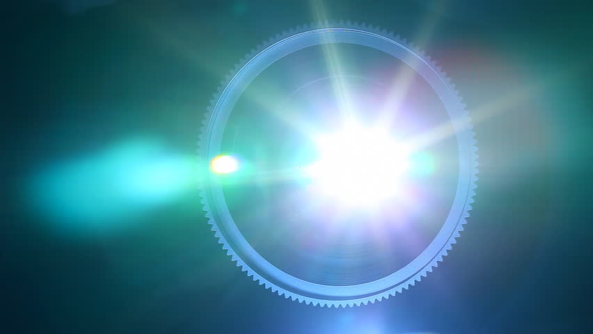 Front view of digital  film projector lens in action.