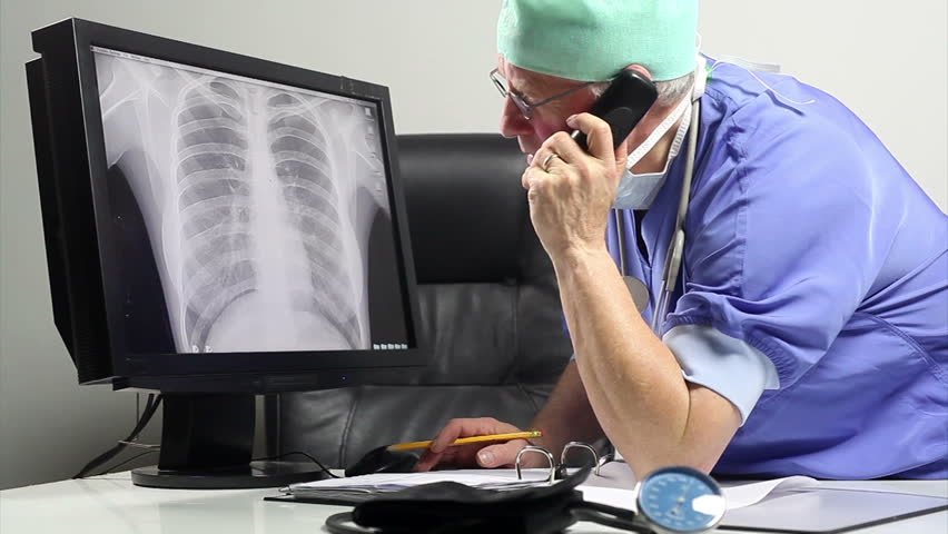 surgeon discusses patient record 