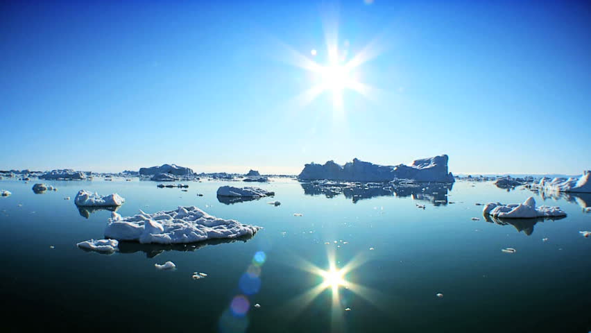 Drifting Past Icebergs Broken from Glaciers