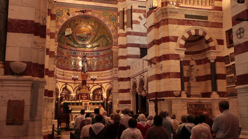  Priest and Church members worship in Notre Dame de la Garde Cathedral Marseille France May 23 2011.