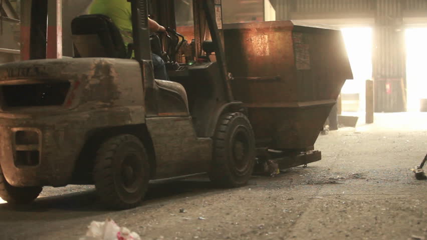 a forklift hauling garbage