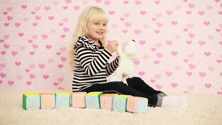 Child playing with a teddy bear 