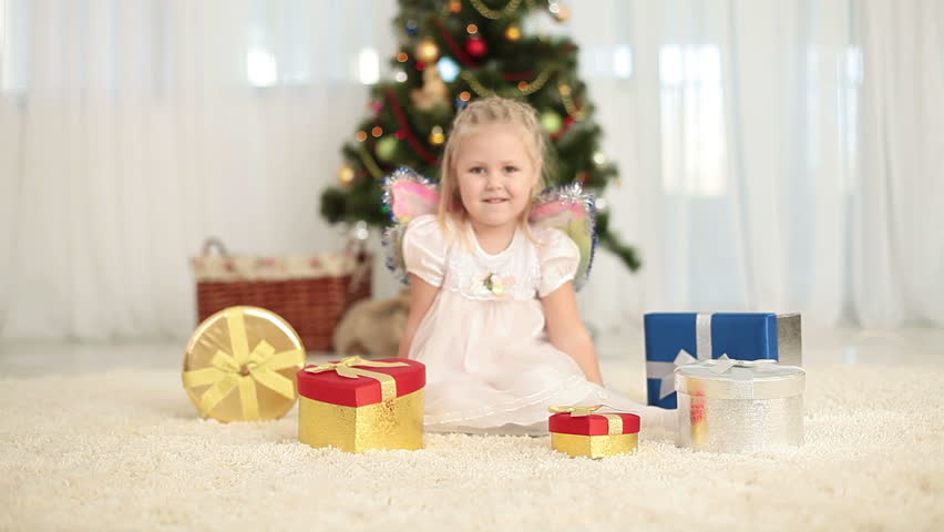 Happy child gets a teddy bear out of the gift box 