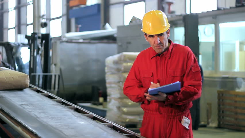 Worker monitoring and checking the number of sacks on the conveyor belt. HD 1080i.