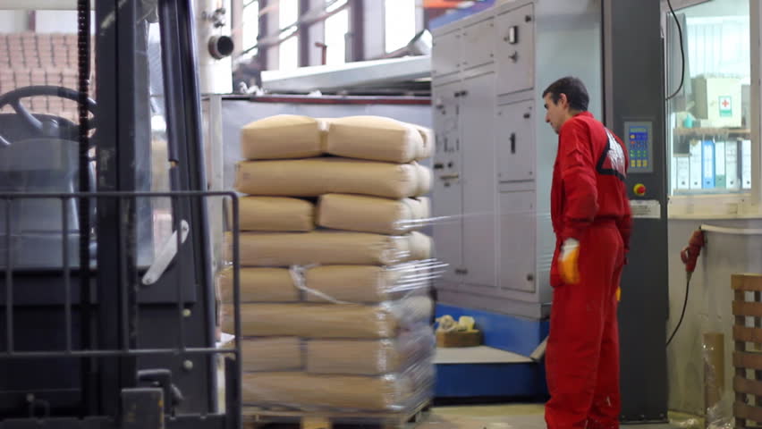 Worker packs bags of sugar