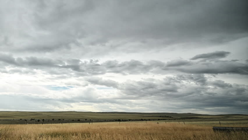 Time lapse over Montana field with rusty tractor