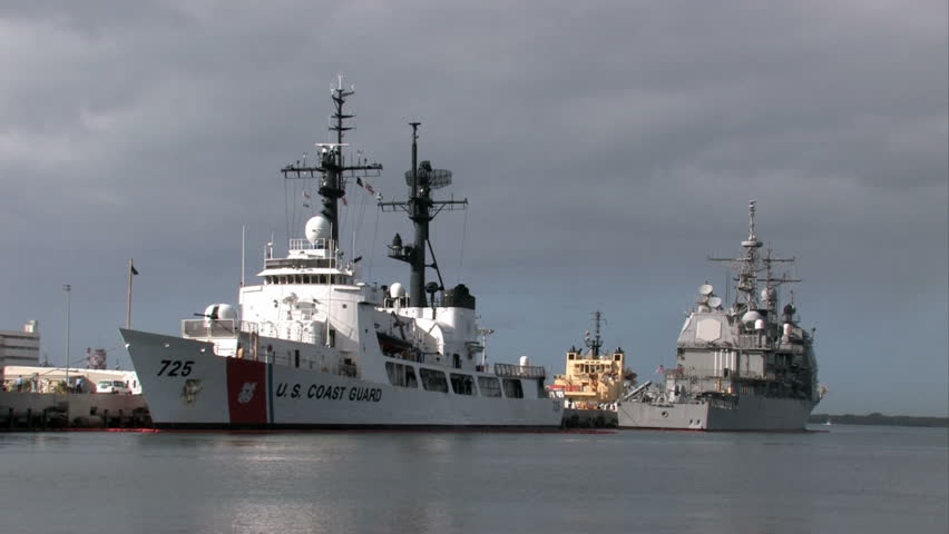 Pearl Harbor Coast Guard and Navy ship. Honolulu, Hawaii. Coast Guard Cutter Jarvis and Navy Aegis Class Cruiser in port. Ships in dock from Navy and Coast Guard. 