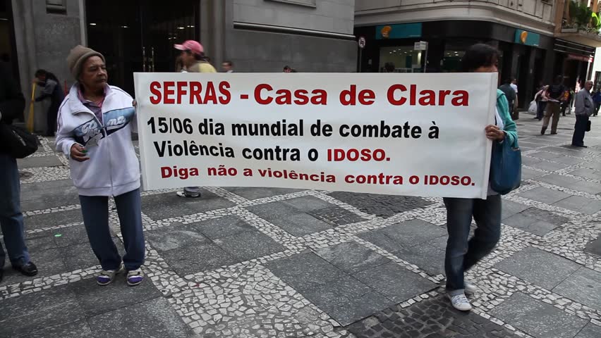 SAN PAULO, BRAZIL - CIRCA JUNE 2011: Demonstrators hold up banners protesting discrimination and violence against females and elderly circa June 2011 in San Paulo.