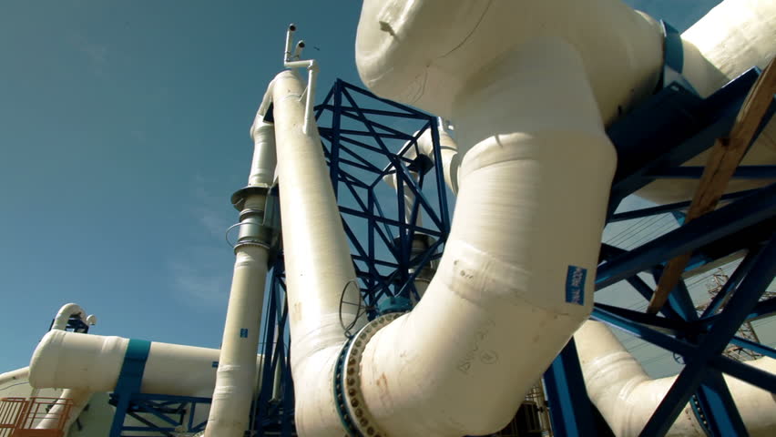 Slider dolly move along jungle gym of huge white water desalination pipes at the IDE Ashkelon desalination plant in Israel.