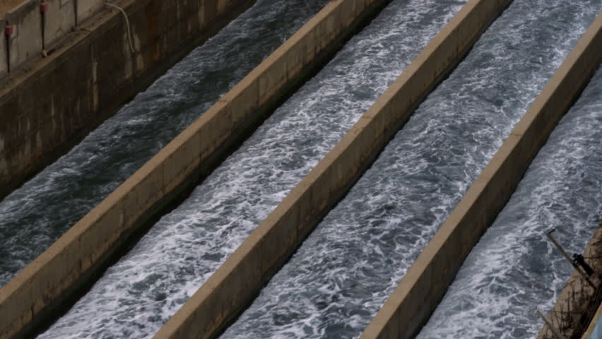 Tilt up to the Mediterranean of the water rushing through four canals back out to the Mediterranean at the IDE Ashkelon Desalination Plant in Israel.  02/28/2011.