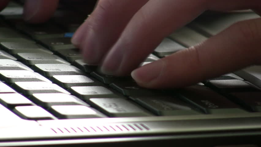 Fingers typing on a laptop Keyboard