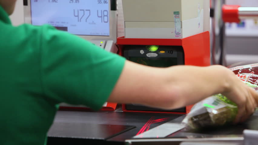 Customer paying for groceries at checkout counter