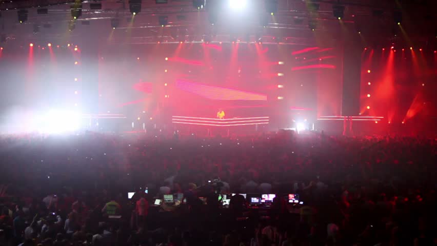 MOSCOW - MAY 6: Popular Dutch DJ Armin Van Buuren on stage, at background of video wall, light show crew among of people on May 6, 2011 in Moscow, Russia.