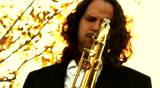 man play on golden saxophone in nature instrumental blow jazz instrument