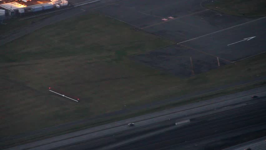 Panning view at night of large runway in Seattle, WA