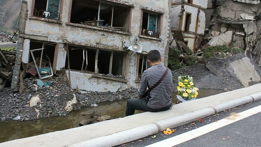 BEICHUAN, CHINA - MAY 12: A man mourns his families killed in the May 2008 quake at his house's ruins in Beichuan, Sichuan Province, China on May 12, 2011.