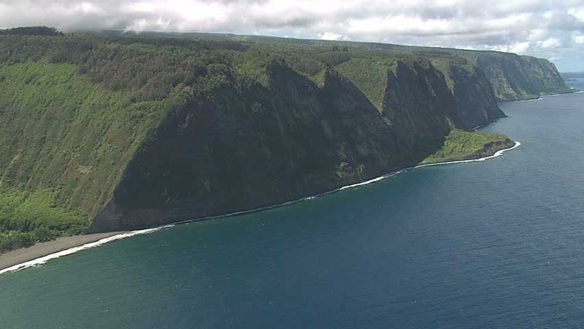 Aerial view of secluded beach surrounded by steep cliffs in Hawaii