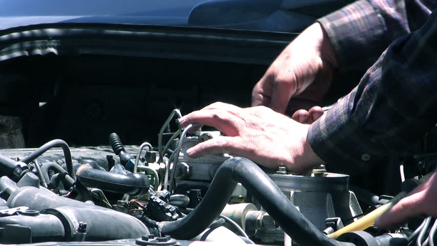 auto mechanic repairing a car engine.
