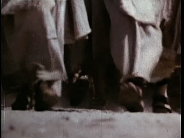 Low angle view peasants' feet walking on dirt road